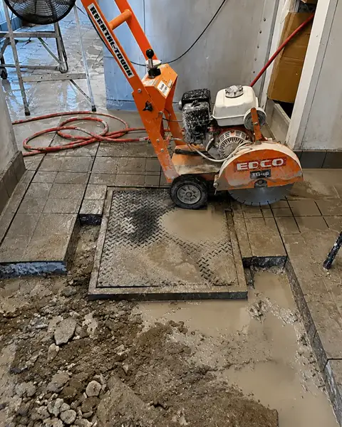 Concrete saw cutting a slab