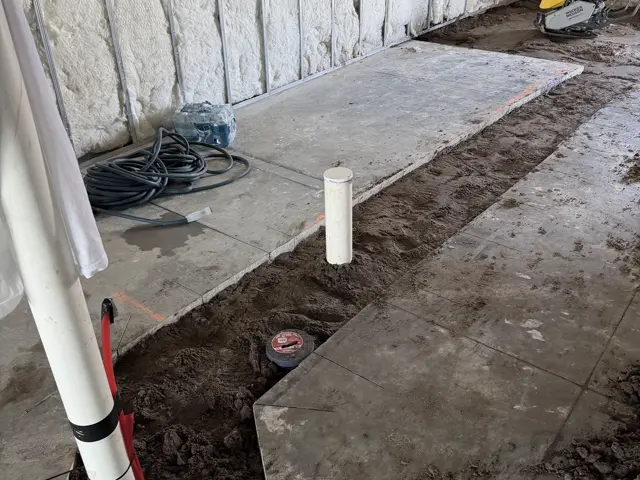 Slab sections removed and the trench dug out for plumbing rough-in