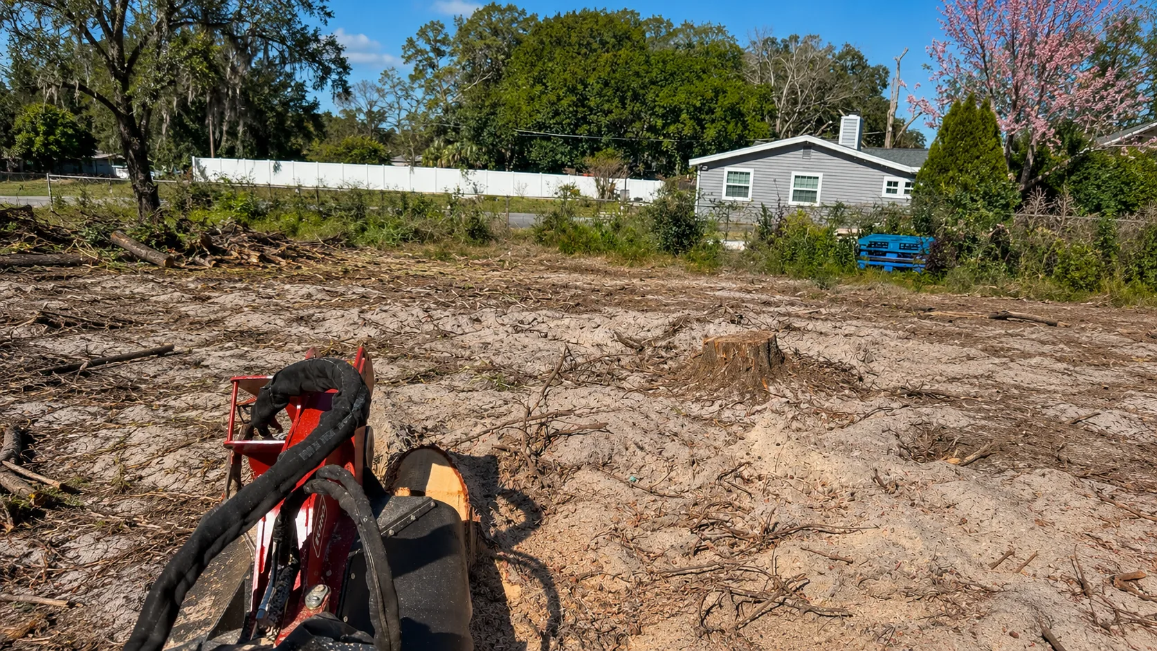 Cleared residential lot with brush removed and bare ground ready for building