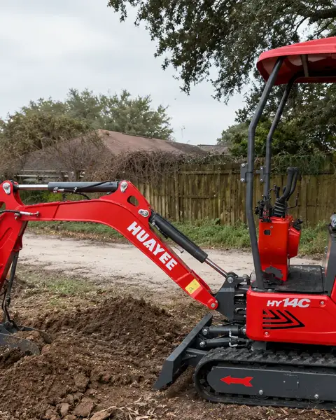 Excavator shaping ground on a job site